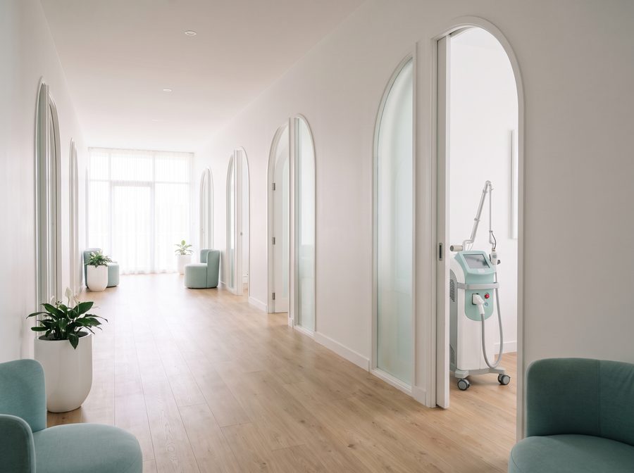 Bright clinic hallway with treatment-room doors